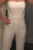 I've been looking for something fun to wear to my bridal shower and when I saw this I was skeptical because I have a long torso and jumpsuits/rompers are 95% a no no. I read the reviews and one person complained about the torso being too long. That's why I bought it! Quite a few sequins have fallen off in the ten min I had it on but I only really need it for one special occasion and if it survives past that then bonus! I might have to get the pant legs hemmed a tad but other than that it's perfect. Also I should add that it's sheer so get some nude undies to wear with it. Strapless bra and you're good to go! - Anna D.