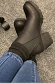 These fit true to size...if you don't wear socks or anything else with them. I'm usually a size 6 and I ordered a 6 and when they came in I was so excited that I tried them on barefoot. They felt great! However, because it's winter and I originally got these to wear with socks to fend off the cold, I had to try them on with socks. They are sooo tight with socks on but it feels roomy at the toe which would be helpful if I could move the rest of my feet around too.
I decided against exchanging them for a bigger size and will try to break them in instead and hope that manages to make them a little looser since the main issue is the top curve of the shoe.
Other than that, the shoe feels nice and comfortable. Because I have thin ankles, I tend to have a preference for boots that fit around the ankle and these give me a little room to move without being being too restricting. - Brenda C.