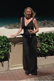 I wore this jumpsuit for a beach vacation and it was perfect! It's a little loose in the shoulders even with a bigger bust so I might end up getting it taken in a bit. I wore it with 2 in heels and the length was great. The material is smooth and stretchy which was also a great feature! - Natalie V.