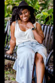It runs extremely large. I had to use garment tape to keep the sleeve straps from falling off my shoulder. It is really versatile and can be dressed up or down. I wore it for photo shoot. - Shan R.