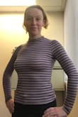 I have a couple dresses from Lulus, both in small, and a blouse that's XS that fit me very well. Based on that, I'd certainly say this runs small. I considered sizing up to medium but didn't want the arms to be too long or the neckline to sag. This is a tad shorter than I might like but looks great with a mid-to-high waisted skirt or pant. If you wear a low-cut bottom, this may be a bit of a crop top. - Ashley P.
