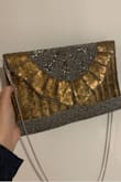 Love it! Very well made and looks a lot more expensive than it is. I used it as a clutch and put the chain in the bag. Depending on the lighting, it almost changes from a gold to a rose gold hue. - Emma S.