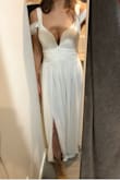If you have big boobs, this dress will flaunt them! I ended up deciding to use this for my wedding dress, and I'm a bit nervous because it is a bit showy, but it fits like a glove & feels like it was made for me. It is on the tighter side since its a xxsmall, but I wanted it tight & I think an xsmall would be too large for me (I'm petite!). It is a bit long but if I can't find heels that work then I'll probably just get it hemmed. Definitely don't need a bra with it. - Nora R.