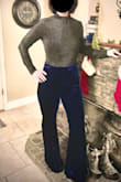 I watched these pants for months and was hesitant to buy them because I'm short and curvy. Finally broke down and bought them and I'm so glad I did! These pants are high quality velvet and fit my curves perfectly. The waist is very high and goes all the way up to my natural 28" waist, above my belly button. It's a side zip waist with a top clasp; the waist band doesn't stretch. I bought the small and they fit my waist perfectly, but I don't have any room to gain weight for sure! The rest of the pants have a stretch to the fabric and look great on my bootie and legs. The legs are very long, so I will either have to hem them or find a super high platform shoe to wear. In the pics, I'm wearing 5" platform heels. - K G.