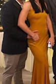 This dress is beautiful! I love the color and the material is nice and thick. I did have an issue with the back of the dress. The back closure is two stretchy cords around buttons and mine were worn, causing the back to not close properly. I was able to safety pin the back without an issue. - Brooke S.