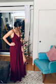 I LOVE this jumpsuit! I wore it to my work holiday party and it was perfect. I wore ~4" heels, any shorter and I would've been tripping or I would have gotten it hemmed. My only complaint was the bust area would've worked better with someone with a larger chest, I didn't wear a bra and had to get some sticky tape and adjust throughout the night to avoid a nip slip. Wouldn't size down though. Overall a beautiful jumpsuit you can dress up or down. - Kayla S.
