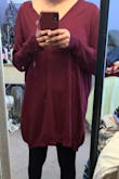 I wanted to love this so much because I love oversized sweaters. I got the size XS/Small but there should definitely be a size even smaller than that. I'm 5'1" so I always have to be careful when it comes sizing - this makes me look terrible! It almost goes down to my knees in the front and hits the back of my knees in the back. It looks like I'm wearing a bag because it's so shapeless. I tried this sweater on 3 different times just wanting to make it work but every time I do I remember how big it is on me. I will probably have to donate it now since the return window has passed. - Brenda C.