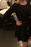 This dress is thick and tight. Gives a nice waist. Feels like good expensive material. A great black dress staple that is a little more modest. - Brenna M.