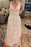 Save yourself the time and trouble of ordering this dress. As a wedding dress, it's awful. Cut was not flattering on me in either the front or back. The sheer overlay feels scratchy and cheap and adds an unflattering bulk to the lower half. - Alison M.