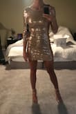 The dress looks amazing on. It does run small. I usually order an XS but went with a small and still can't zip the back all the way and feels very snug. Looks amazing with the heels. - Jackie W.