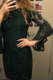 Fit pretty true to size, not as tight as a body con but not as loose as a fit and flare. Loved the flared sleeves and got compliments all night long! Lacey material was as expected - Maddie Z.