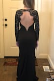 The back of the dress is really pretty! It does run a little large and is baggier on the tummy. First ordered a small and had to return it for an XS and that fit much better. Will need to get it hemmed because it's a little too long. Overall, a really cute dress though. - Hannah W.