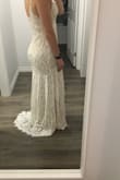 Fits as expected. There is a little stretch which made it super comfy. The pleats in the front were a bit weird so I'm having a seamstress reverse them. Other than that it's great. A perfect wedding dress for someone not looking to spend a ton of money. - Emma H.