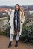 I bought this teddy coat for my trip visiting my family in Germany over winter. I normally wear a size medium in everything. I purchased both the small and medium (after reading reviews and seeing it ran large) but nope, it fit true to size! I kept the medium. There wasn't a big difference between the two sizes anyways. Medium fits me perfectly! This coat kept me SO warm on the coldest of winter days and got so many compliments! It is my absolute favorite. The quality is incredible too. The inside lining is absolutely beautiful too with the elegant pattern it has. Would recommend this to anyone! - Cheyenne F.
