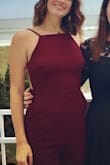 I wore this to a wedding and the top was very flattering and fit nice and snug. The back is completely open but the material from the front reaches around the sides so there isn't any side boob. Everything held in place very nicely even though the back was so open. The legs on this jumpsuit are very wide and long - I had to hem them which I rarely have to do. But if you like that wide-legged look, it'll be great. Overall I felt very comfortable, danced, and loved the way it fit. - Gabrielle H.
