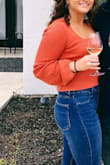 Lulus usually has pretty cropped tops so I was expecting this not to be a full length blouse. The color and material are amazing, but yes it's very short. I wore high waisted pants with it and it worked! The square neck and tied back make it worth it. - Victoria M.