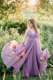 I wore this for my engagement shoot and it was a perfect choice. The color is very true to the image and very flattering. The twirling depicted is also spot on- this dress is perfect if you want that dramatic dress shot. The front is separate though (you can see that in my first photo. Not an issue though. I wore 3 inch heels and did not need to have it hemmed. It also looks really great with a denim shirt tucked over it! I'm small on top and the bust was a bit loose. I would have altered it but I ran out of time. Only thing to know is because there is a lot of fabric, you could get hot in it and if your traveling, this dress will add weight to your suitcase. - Christine B.
