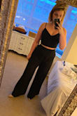 I bought this on a whim (I have expensive whims), and I'm so glad I did! The material of the crop top is thick and high quality, and because I can adjust the tightness of the straps and the back lacing, I don't need to wear a bra and can still feel supported. The pants were long, but when paired with about 3" heels there's probably no need to hem (my legs are "regular" length in terms of jean sizes - neither short nor tall). As other reviewers have said, the side slits are HIGH so when you sit and the material drapes away, you'll be showing full side thigh/cheek. (I"ll be self-tanning before breaking out this look.) I had a little trouble zipping them up in back on my own, so in my pictures the pants are on backwards. LOL. I might have sized up to a large since the waist was snug, but I had also just eaten a huge chicken breast right before try on. Overall, they are sexy and sassy and a definite keeper! - Tori L.