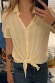 Super cute top! The material isn't great and wrinkles pretty easy, but I've worn it on warm-weather vacations and get tons of compliments, the yellow is light and really pretty. - Allie G.