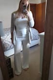 I totally love this jumpsuit! I bought a medium and was a little nervous it would be tight around my legs but it is not at all! It fits so perfectly! I am wearing it to my bridal shower so I added a cardigan seeing how my shower is in March. - Samantha C.