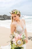 I wore this gown for my Maui elopement and it was absolutely STUNNING and looked beautiful in our pictures! I felt like a mermaid bride with the scalloped beading and flowing skirt. I'm on the short side, so I got the skirt hemmed to fit my height. I do wish I had gotten the top adjusted with different cups that fit my bust better, BUT either way I still loved this dress and I felt so beautiful on my special day. 

A couple lines of beading did come loose towards the end of the night, but it wasn't super noticeable. If youre going to be doing a lot of dancing, I recommend bringing a small sewing kit just in case this happens. - Kayla J.