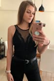 I have been looking at this top for a while now, but have always been hesitant about: "Is it too revealing?" ... "Can I wear a bra with it?" ... "Will this even fit me? I mean... it is a body suit." I usually switch between XS and S in Lulus. And I have to say... I'm in LOVE! I really wasn't sure but thought I would take a chance! The material is amazing because it's quite durable and thick, but still has some stretch in the back so you're not struggling to put it on. I actually wear a bra with it as well! (Nude). I can barely see it. No more than any other top that I own. This top looks amazing with high waisted jeans, a long maxi skirt... almost anything. I feel like a Rock Star in it and have gotten so many compliments! - Alexis E.