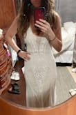 I love this dress so much! The color and detail are beautiful! This is my wedding dress! I ordered this dress in different sizes and I ended up going with the small it fits me snugly but that's what I was going for. The beading is so gorgeous and they have an iridescent shine so even though the dress isn't super white, it is shimmery due to the beading. It's unique and totally what I was going for :) I will have to get it hemmed because it's a little too long in the front for me and I plan to use 1.5 inch heels but for higher heels it might be ok as is. - Angelica B.