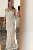 I absolutely love this dress! The ivory overlay glows on top of the nude under layer. The dress cut is incredibly flattering and makes me look like I have more of a waist than I really do. The top stays in place and feels very secure when moving. The dress is tight against the body, but looks great in photos and video. I am wearing 4" heels in this photo and am only 5' and the dress just hits the ground. - Cara J.