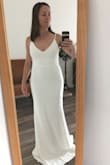 I love the shape of this dress and the material it is made of. It's elegant but sexy. The white color is hard on the body because you see every seam and everything line/layer/curve under the dress. The other darker colors seem like they're a little more forgiving. The XS fit my body well, but I would have had to hem quite a few inches off the bottom and would want to replace the straps with ones that do not have the adjustable pieces on them to make it feel more formal. - Cara J.