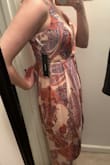 Short people - the back might brush the ground. The chest area is flattering and the straps work well to adjust for smaller chest sizes. The zipper makes it easy to get on but kept getting stuck when I took it off. I think if the waist line hit lower around the actual waist this would be really flattering. But right now on my body type this isn't the most flattering. The excess material in places makes my butt look flat instead of accenting it and my figure got lost in the flow of fabric. The fabric photographs well but looks a little dull in person. - Katie B.