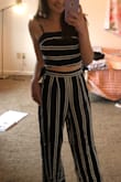 I LOVE this two-piece jumpsuit! The top ties in the back, so it can be worn as tight/loose as desired. The pants zip in the back, but also have a cinched/stretchy segment of the waist band so they will not fall down. The material is flowy and super comfy! I am so excited to wear it on my upcoming tropical trip! - Julia B.