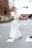 Bought this dress for my wedding and it is beautiful! The lace on the top is gorgeous, and I love the side details. The underskirt is not flowy, very tight unlike the two skirt layers so if you're big on the bottom like me and have the time, you may want to get that part altered. I didn't have the time and it was bearable, I just had to tug a lot. It still wears beautifully! Also, make sure you have a sticky bra because a strapless bra shows through the sides. - Ashley M.