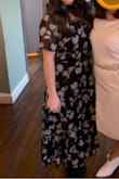 Loved wearing this dress. Since I'm short the mid length was a little longer on me than the model in the photo but still stopped right above my ankle. Only thing I would say is the sleeves were a little tighter than I would have liked but the rest of the dress was super comfortable! - Jackie P.