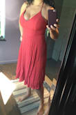 First of all, after wearing the dress for a few hrs I noticed that the side seam was coming undone. Lulus was gracious enough to give me a store credit as I had worn the dress already. But the dress straps system is just weird. The straps that adjust the front of the dress are attached to the straps that adjust the back so I you want to tighten your straps you need someone to help you tighten the whole dress in the back. With my big boobs I needed to have the front pretty tight so it would be supportive but it's not easy to tight the whole thing from the back and overall pretty uncomfortable. I decided to alter it by cutting the straps and separating the two systems and making it more of halter top (see second photo). Now I can adjust the the top and the torso separately. This dress has to be worn without a bra which may not work well for bigger breast women. I do love the rust color and after the alteration is more comfortable and manageable. - Melina C.