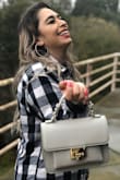I love this purse it goes with everything! Although it's small it definitely can fit a good amount of things! - Bibianna R.