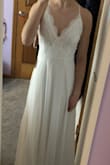 I absolutely adore this dress. It fits perfectly and has a long flowy hem which is exactly what I was looking for. The straps cross in the back which is super pretty as well. - Hannah H.