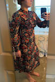 I really love the idea of this dress, but if you have boobs at all, it is not the one for you. I tried to do photo justice to the uniboob this dress gave me once I got it zipped, but I can't really overstate it. It is TIGHT across the chest, and I got a Large (athletic build, usually float between a Medium and Large, lean towards Larges at Lulus). The pattern is really fun, and even on a 5'5 girl with a long torso and stumpy legs, I actually really like the length with the right shoe. The chest pulls so much that the neckline gets tugged down and the keyhole in the back is slightly more open than it should be. There are dart seams along the sides of the chest but I truly think they're just for show, because there's no way this dress was designed with any breast tissue in mind. Other than that, the cuffs are a touch small to get a normal hand/wrist through since there's no stretch, but once they're in, it's comfortable and fine. Such a bummer about the chest and ribcage being so unforgiving. - Colleen B.