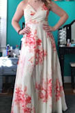 I got this dress for prom and I absolutely love it! The color is so pretty and the flowers don't look like you're wearing your grandma's curtains. It is a wrap dress so I can't put it on alone, I need help managing the ties. The dress isn't too long with heels. - Jacqui H.