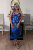 I loved this dress! Based on reviews I ordered a medium and it fit perfectly. Make sure to order the right size because there is no stretch in the material. But the dress itself is so flattering. Straps are adjustable and I just tightened the straps and wore without a bra. The color totally popped with a spray tan. Since I'm shorter it was longer than a midi, but not quite full length. I got a ton of complements! Highly recommend this dress - Brianna W.