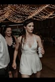 Got this romper for my wedding to change into towards the end of the reception. Chose it because it had the same style as my wedding dress on top. So glad I made that decision because it got so hot I wouldn't have had fun at my wedding if I didn't change into this! Everyone loved it!! And I'm glad I can wear it again unlike my actual dress! Picked this photo to emphasize how this romper allowed me to be the fun bride in action! - Amelia P.