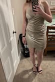 I ordered this dress twice hoping the color was just a mistake but it is definitely not as silver as the picture shows it to be. I wanted to wear this to my bachelorette in Vegas. I contemplated keeping it but the color just wasn't enough for me, it was darker with gold tints in it. I am pretty bummed because I really did love the fit of this dress! - Faith B.