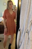 The dress is super cute. I am in between a small and medium, but I decided to order a small for the dress. The dress length was perfect for my height. There is a hidden button for extra security in the chest area.  The material is thick and not sheer at all. I'm wearing two different shoes to show that you can wear it different ways. - Aubry G.