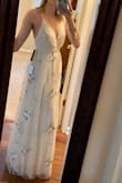 I loved the feel of the dress and fit on me. I am looking for a dress for our elopement so I'm not looking for a white wedding gown. I loved the flower detail on it as well. I did not like how the slip underneath stopped at the knees. If I had gone with this I would have needed it altered for a longer slip. I also with the fabric was a little thicker. Overall, I could have made adjustments and used the dress. I ended up going with another dress, but would recommend this one. Thank you for being so easy to work with! - Erin P.