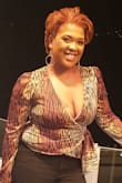 I had to put a safety pin in the front also the sides of the low cut top kept coming up. A size up would have been way too large since it was cut so low. Everyone loved the style I received lots of compliments on it. I wasn't a fan of readjusting the top during the night. - Tomekhia V.