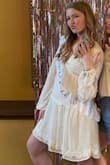 I bought this dress for my bridal shower and it was perfect! I will say, I was expecting a true white and it is a little more cream/off white, but still cute. I was also worried about the deep cut, but with a bralette I felt very comfortable. The skirt is a little see through, but wearing nude spandex/underwear should do the trick just fine. - Lauren B.