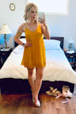 This is a really nice mustard color dress, kind of that gauzey material. It is quite short (but I am tall). The bra situation is hard because it's low cut in the front, back and sides. I wore it with a sticky bra but will probably use this over bathing suits for the most part. - Jess L.