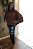 This poncho sweater fits true to size.  Since it's heavy enough to keep warm, I didn't wear any shirt or blouse underneath. I wore it with some distressed jeans.  I received a lot of compliments. I have no regrets about purchasing this poncho sweater. - Jannie M.