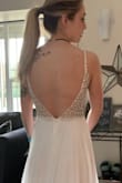 I ordered this as a budget friendly wedding dress but with the Coronavirus chaos happening, I may have to postpone the wedding. The dress was even better quality in person than I expected. It's very fitted and detailed on top, and simple and elegant and flowy on bottom. It is potentially see through so careful of your undie color choice = 
Also, I am 5'4 and got a size 2 dress but I would definitely have to take a few inches off the bottom because it's extremely long in the front - Alyssa L.