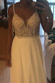 The dress was exactly as pictured, but 10 times better in person. I don't really like to order things online because I like to feel and see items in person. The detail on the top of this dress is what I was looking for at the price that I wanted to spend for our elopement. I couldn't be happier! - Br L.