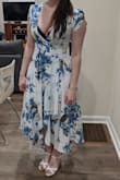 This is a beautiful dress that is great if you love dresses that twirl when you spin! This does run small though, I originally ordered a small and it was too big so I exchanged it for the XS. The XS is a little tight and I will either have to alter the top or where something underneath because my Bcup boobs fall out of the XS but they were not even close to being able to fill out the Small but you can also definitely see the bra in both, not sure why the top was destined this way, but the rest of the dress worth it! Also except the neckline the even darker colored bras don't show through the white material, I was very impressed. Customer service was fantastic when I asked them about the size and they gave me the exact measurements for the S & XS for this dress so for anyone else who's curious they are:
XS
Bust: 31.5"
Waist: 26"
Hip: 34"
Length: 39.5"

Small
Bust: 33 "
Waist: 27.5 "
Hip: 36 - Catherine K.